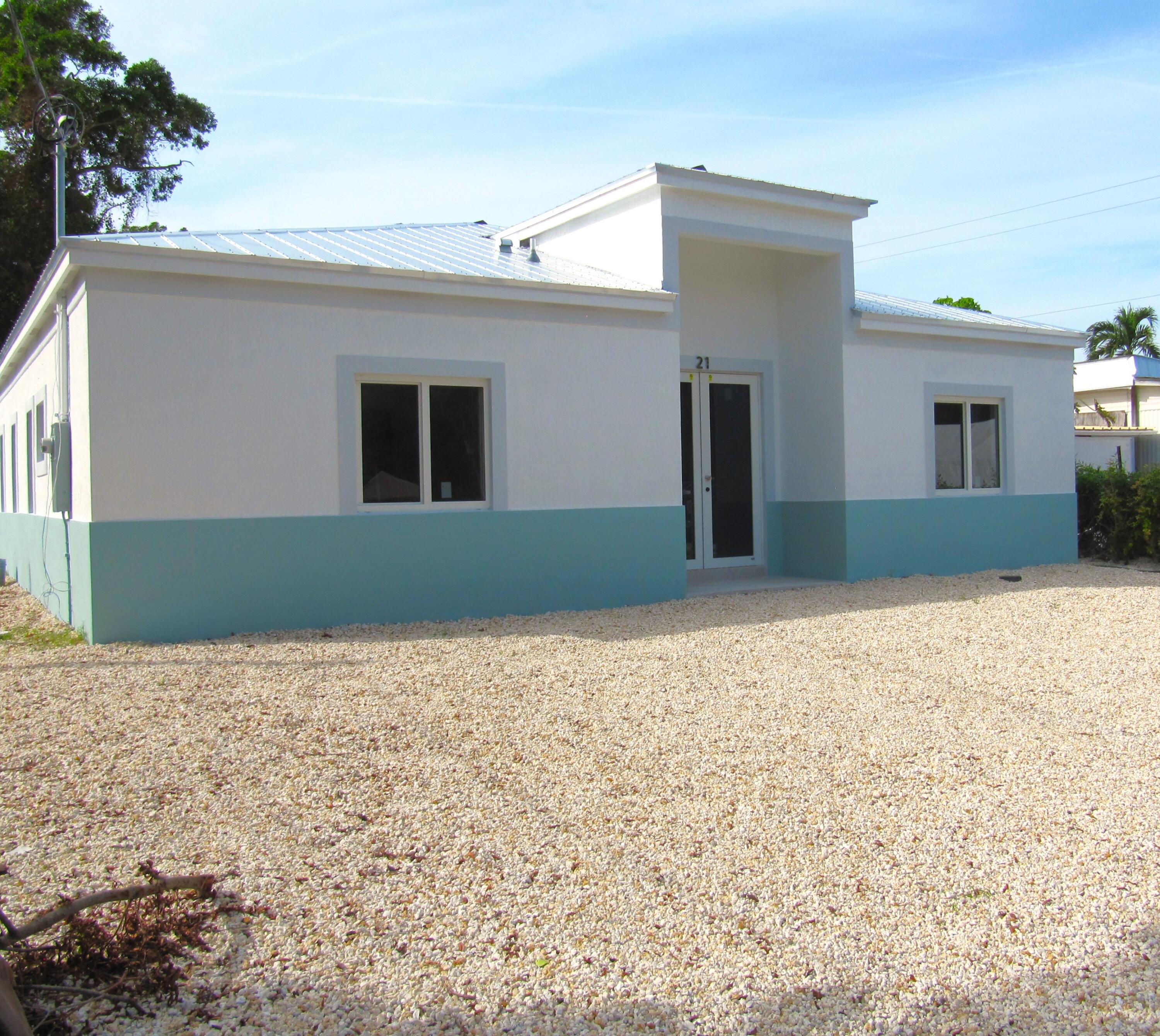 21 Tina Place Key Largo, FL 33037 - Photo 1 of 15 a front view of a house with a yard