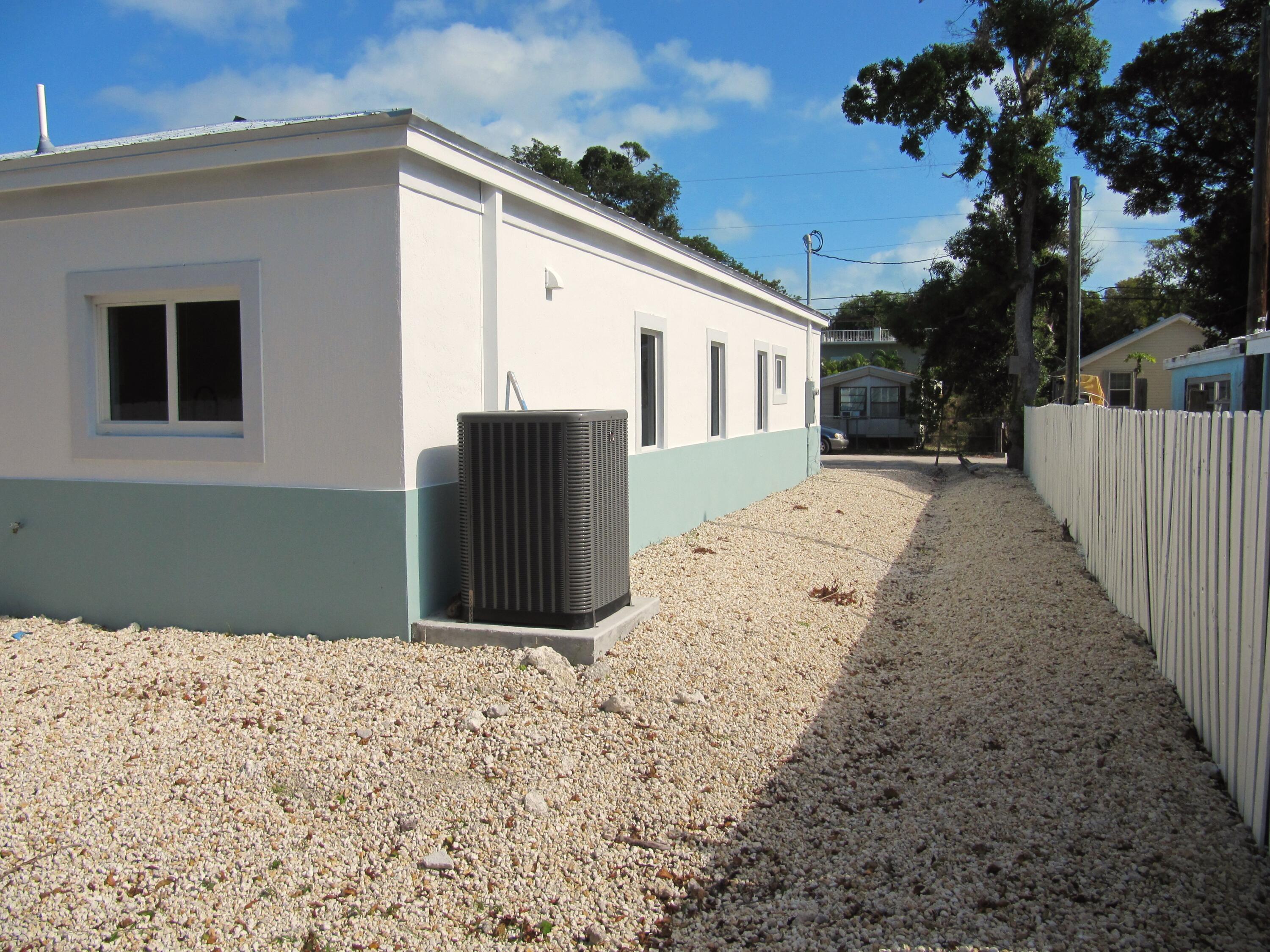21 Tina Place Key Largo, FL 33037 - Photo 14 of 15 a front view of a house with a yard