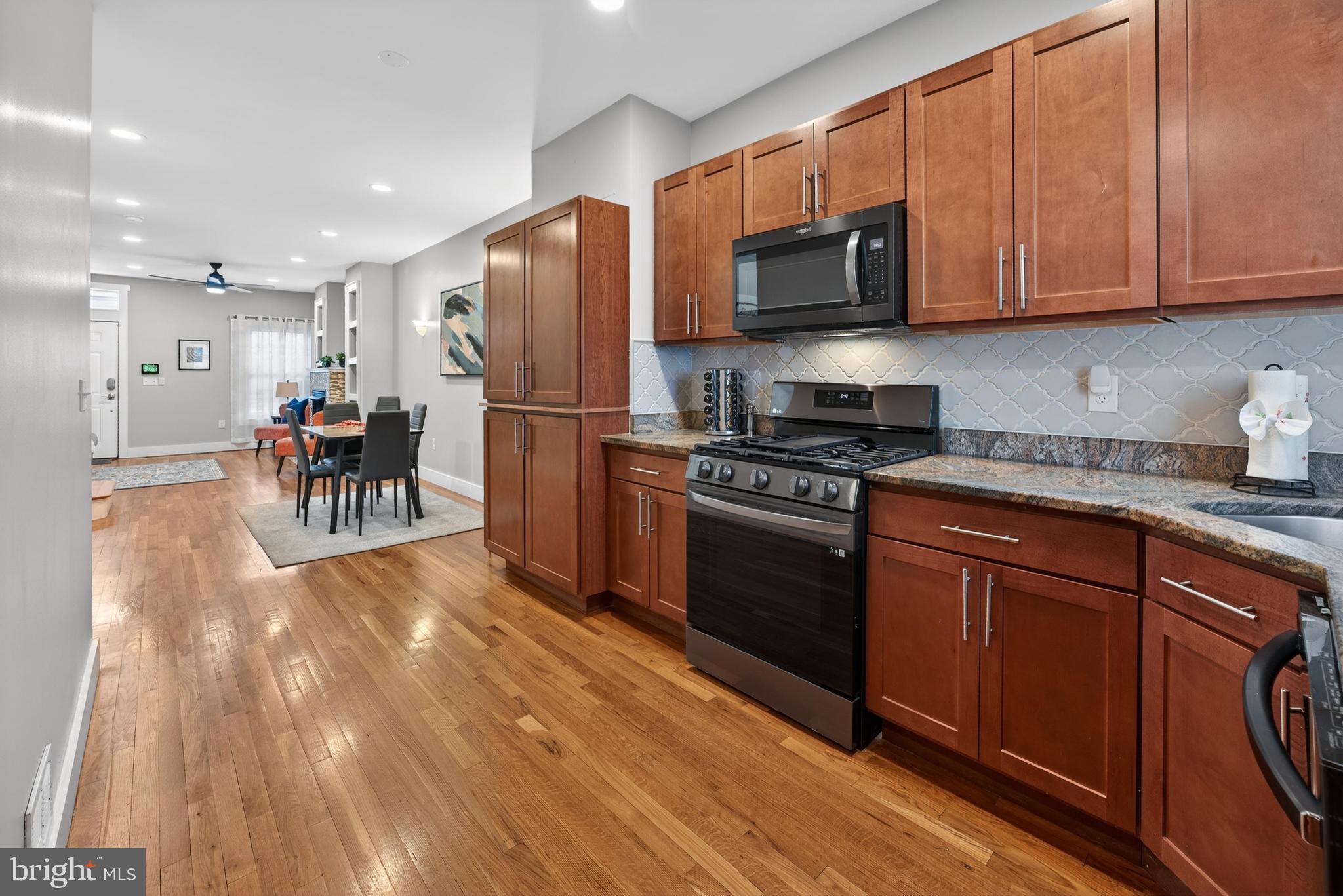 736 New Street Camden, NJ 08103 - Photo 8 of 20 a kitchen with stainless steel appliances granite countertop a refrigerator stove microwave and sink