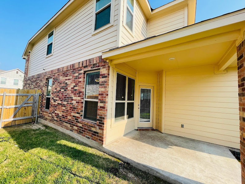 4012 Birdwatch Loop, Unit 8 Pflugerville, TX 78660 - Photo 13 of 23 a front view of a house with a garden