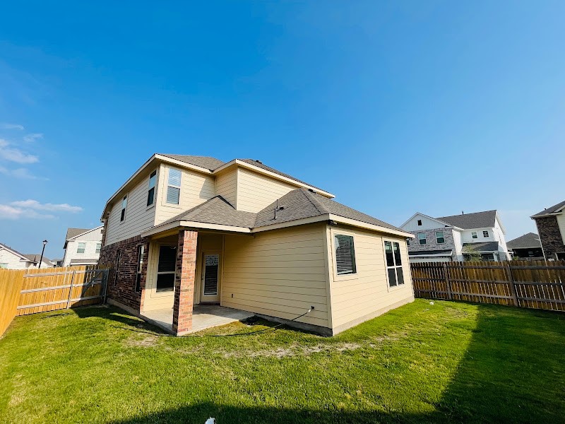 4012 Birdwatch Loop, Unit 8 Pflugerville, TX 78660 - Photo 14 of 23 a white house that has a big yard in front of it