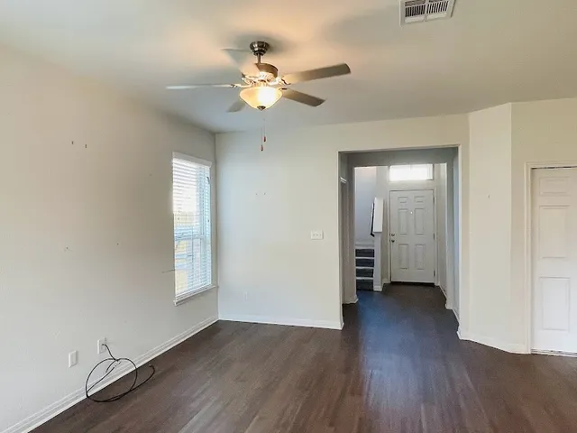 wooden floor in an empty room with a window