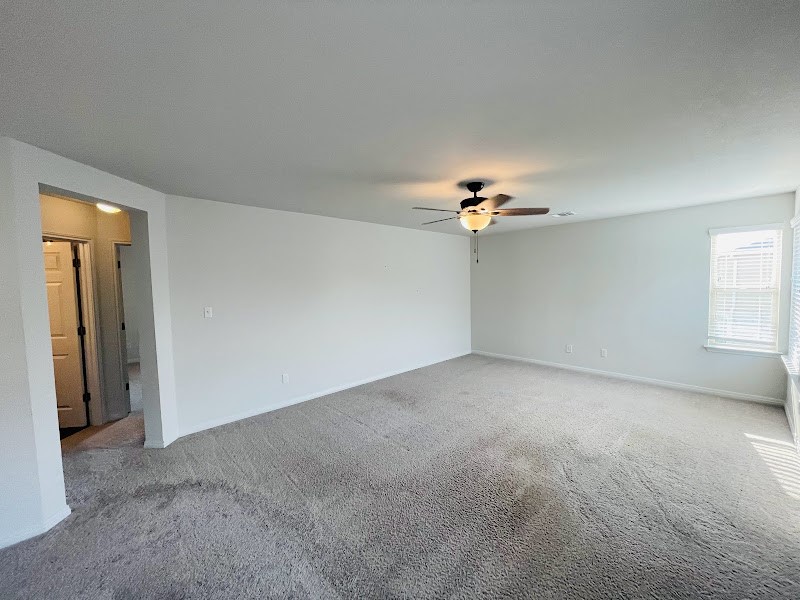 4012 Birdwatch Loop, Unit 8 Pflugerville, TX 78660 - Photo 18 of 23 a view of a livingroom with a ceiling fan and window