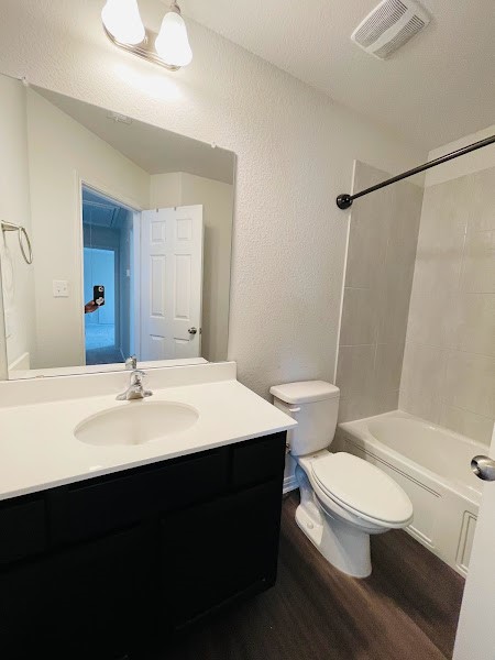 4012 Birdwatch Loop, Unit 8 Pflugerville, TX 78660 - Photo 20 of 23 a bathroom with a sink a toilet a mirror and shower