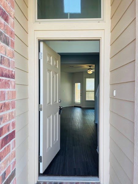 4012 Birdwatch Loop, Unit 8 Pflugerville, TX 78660 - Photo 2 of 23 a view of a hallway with wooden floor and a living room