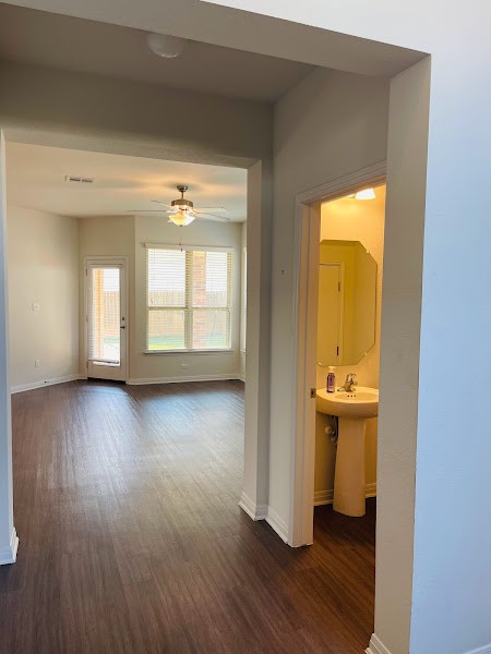 4012 Birdwatch Loop, Unit 8 Pflugerville, TX 78660 - Photo 3 of 23 wooden floor in an empty room with a window