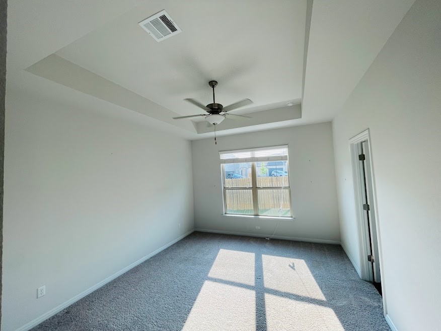 4012 Birdwatch Loop, Unit 8 Pflugerville, TX 78660 - Photo 9 of 23 an empty room with windows and ceiling fan