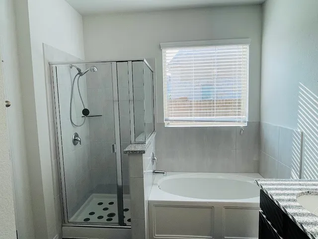 a bathroom with a granite countertop sink a toilet and shower