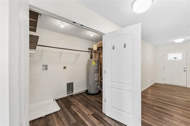 a view of a hallway with wooden floor and closet