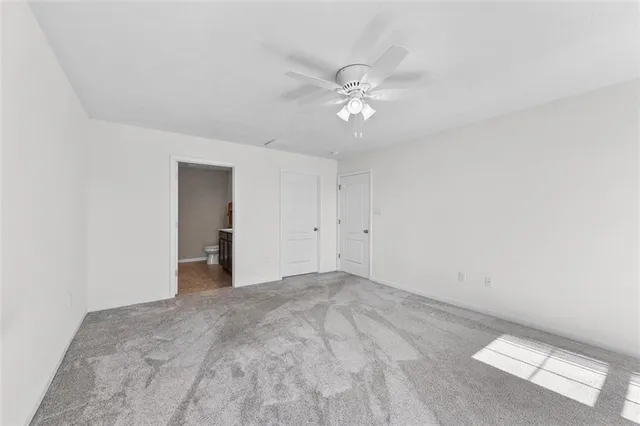a view of a big room with a ceiling fan