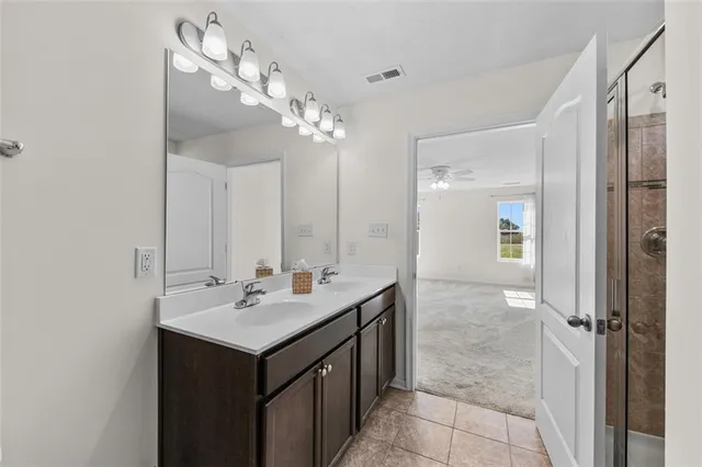 a bathroom with a sink a mirror and a shower