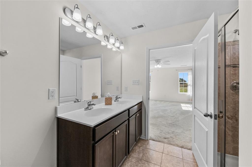 1024 Colonial Drive Uniontown, PA 15401 - Photo 18 of 33 a bathroom with a sink a mirror and a shower