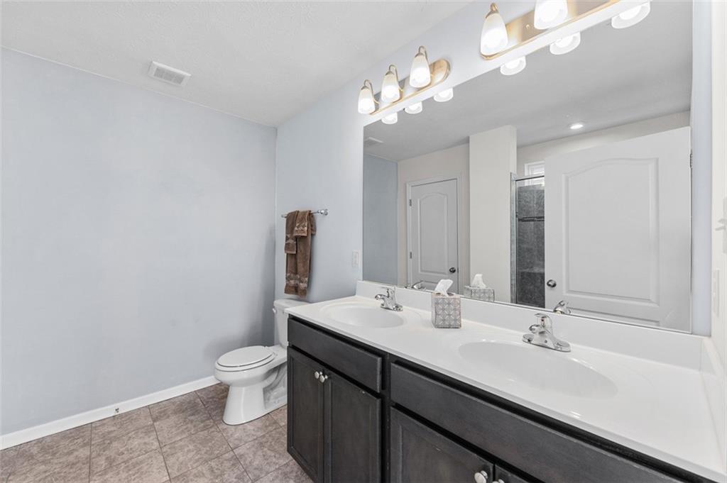 1024 Colonial Drive Uniontown, PA 15401 - Photo 19 of 33 a bathroom with a sink a toilet and a mirror