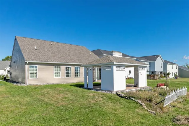 a view of a yard in front of a house with a garden