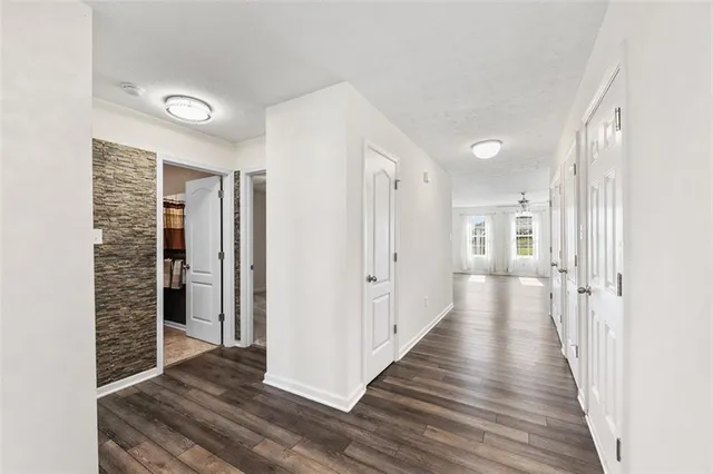 a view of a hallway with wooden floor and staircase