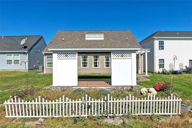 a front view of a house with a garden
