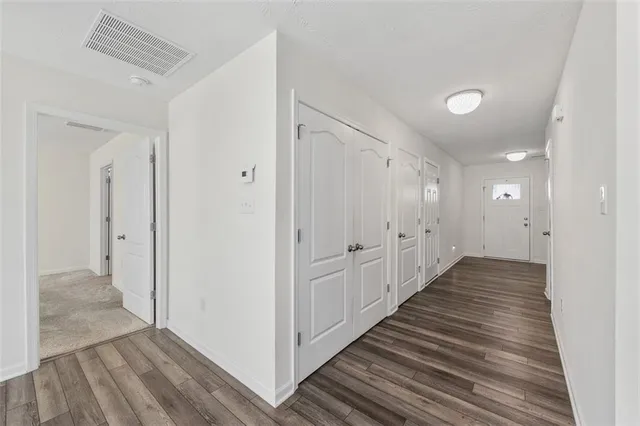 a view of a hallway with wooden floor