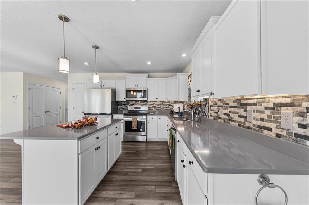 1024 Colonial Drive Uniontown, PA 15401 - Photo 6 of 33 a kitchen with stainless steel appliances kitchen island granite countertop a sink and cabinets