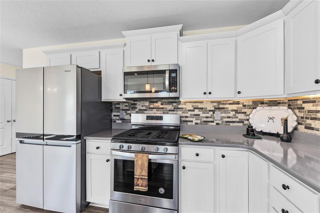 1024 Colonial Drive Uniontown, PA 15401 - Photo 9 of 33 a kitchen with granite countertop a sink stove and refrigerator