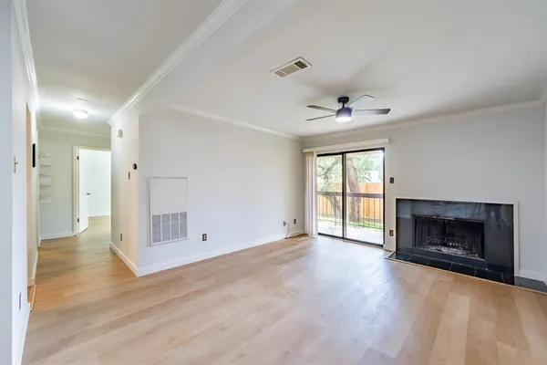 wooden floor in an empty room with a fireplace