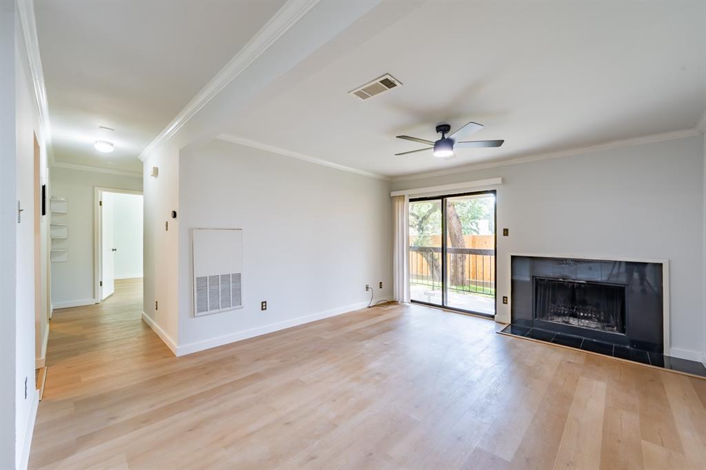 8600 Fathom Circle, Unit 1407 Austin, TX 78750 - Photo 1 of 26 wooden floor in an empty room with a fireplace