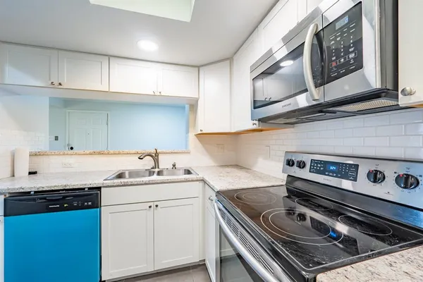 a kitchen with a stove and a sink