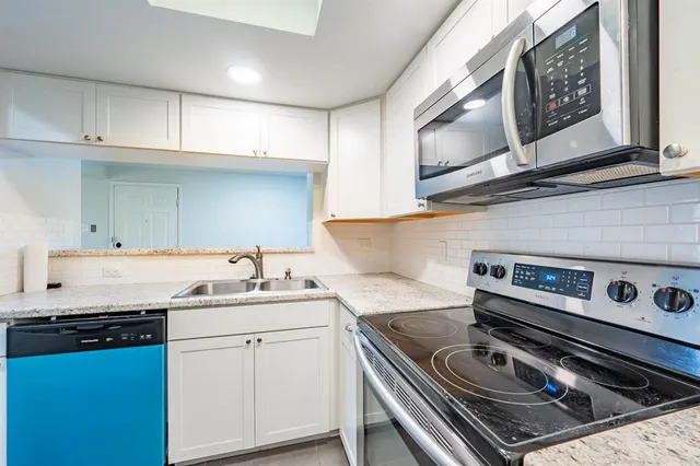 a kitchen with a stove and a sink