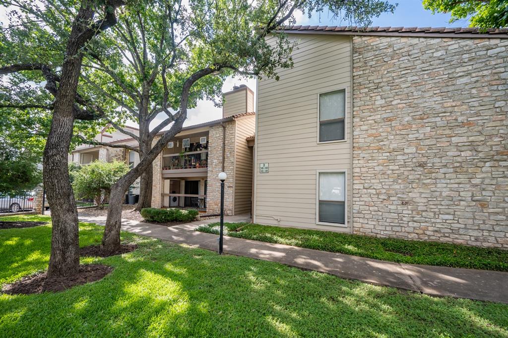 8600 Fathom Circle, Unit 1407 Austin, TX 78750 - Photo 21 of 26 a front view of a house with a yard and trees
