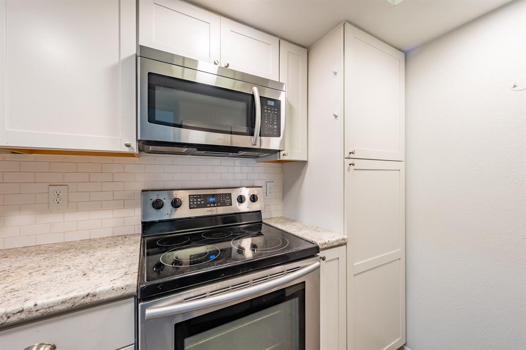 8600 Fathom Circle, Unit 1407 Austin, TX 78750 - Photo 10 of 26 a kitchen with a stove and a microwave