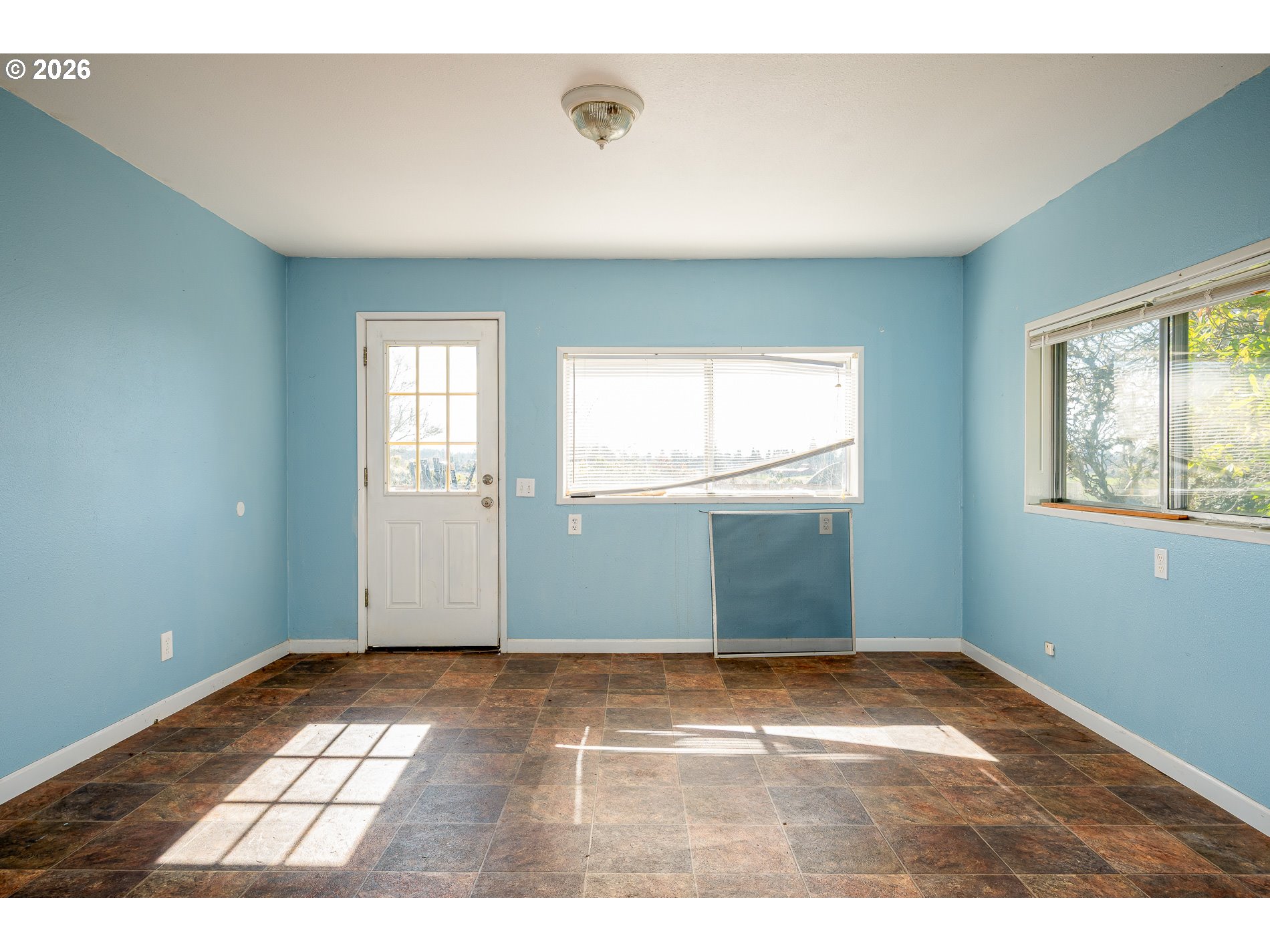 32404 Southeast Pipeline Road Gresham, OR 97080 - Photo 18 of 48 a view of an empty room with wooden floor and windows
