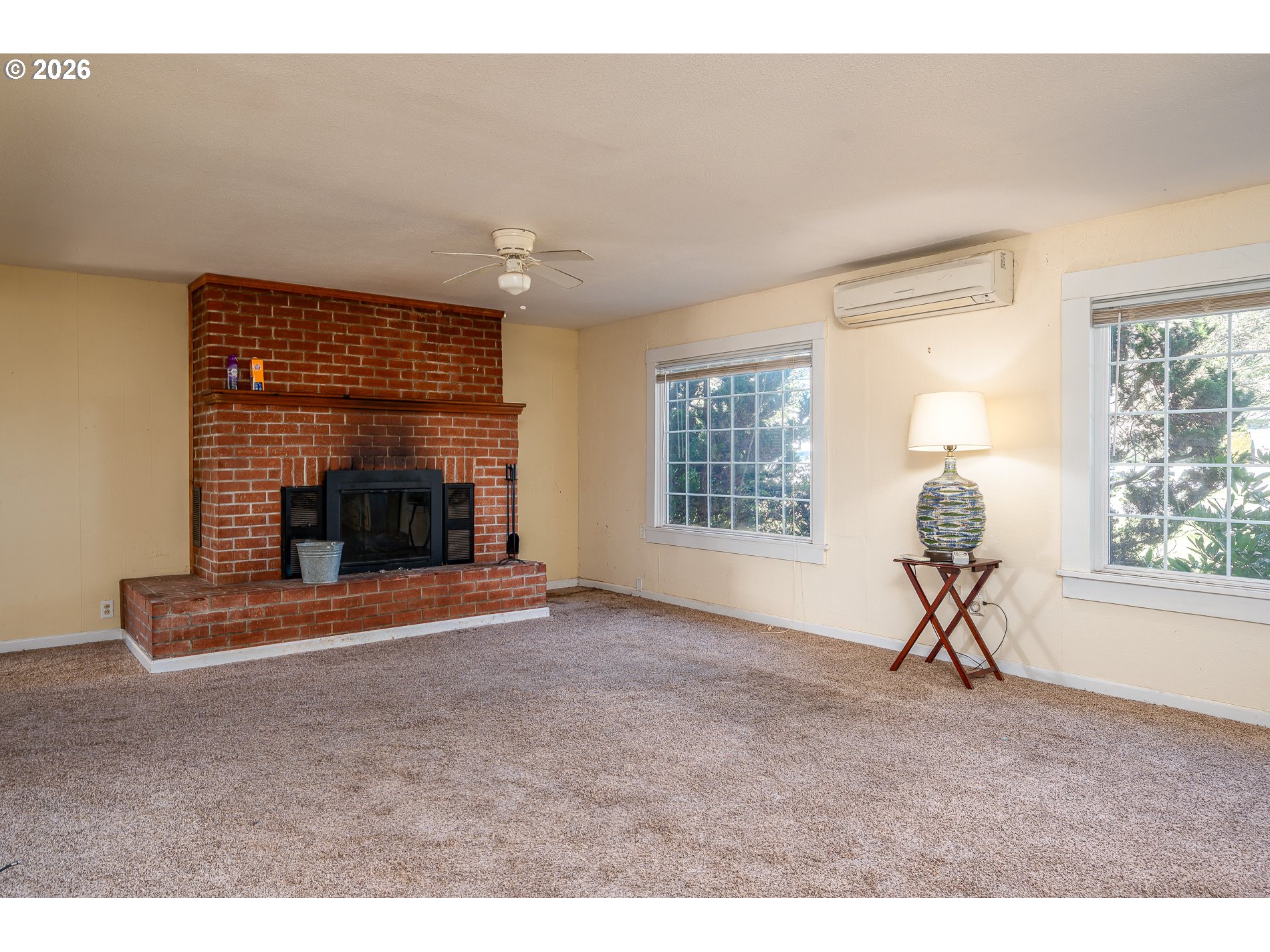 32404 Southeast Pipeline Road Gresham, OR 97080 - Photo 10 of 48 a living room with a fireplace and a window