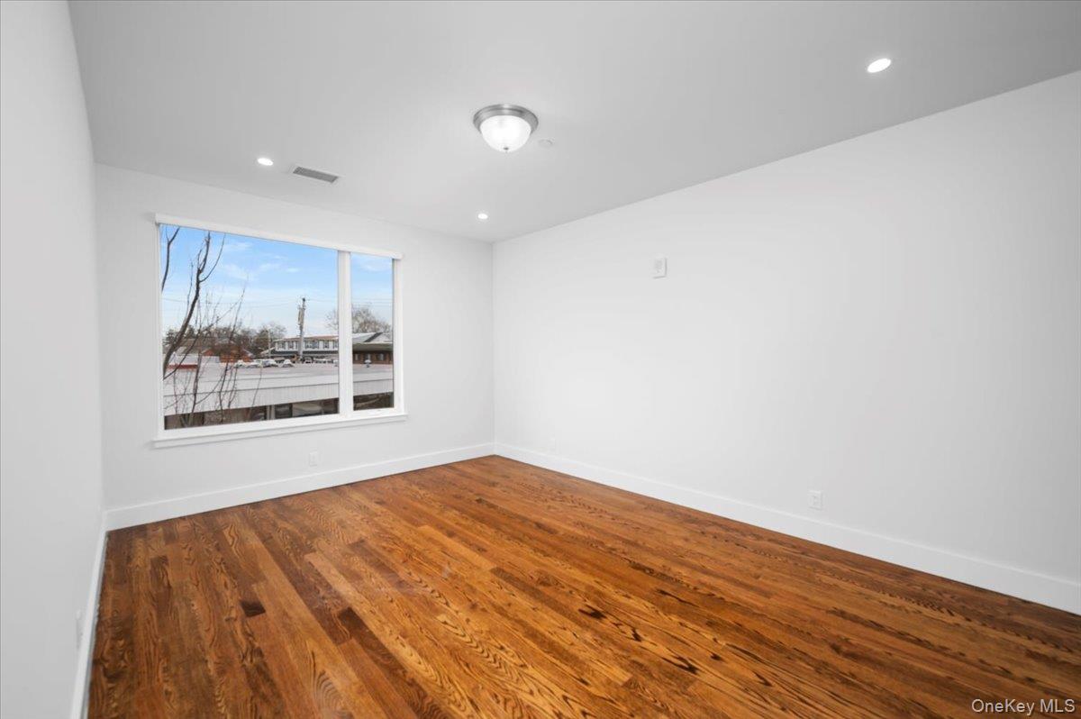 422 East Boston Post Road, Unit 303 Mamaroneck, NY 10543 - Photo 11 of 23 a view of an empty room with wooden floor and a window