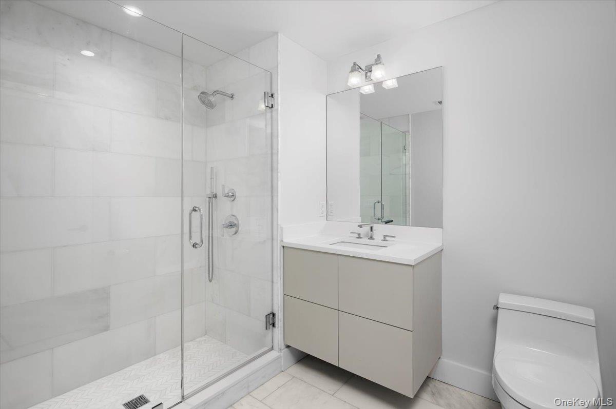 422 East Boston Post Road, Unit 303 Mamaroneck, NY 10543 - Photo 17 of 23 a bathroom with a sink a toilet and shower
