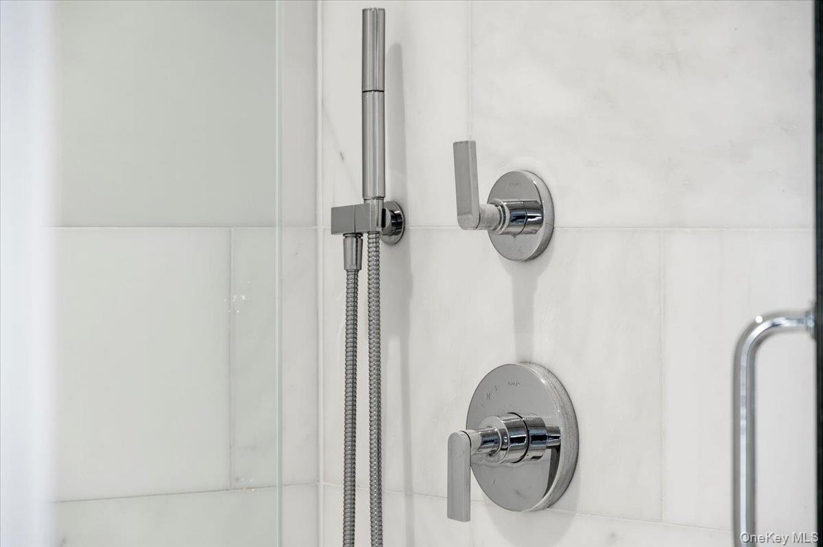 422 East Boston Post Road, Unit 303 Mamaroneck, NY 10543 - Photo 18 of 23 a bathroom with a granite countertop shower and a sink