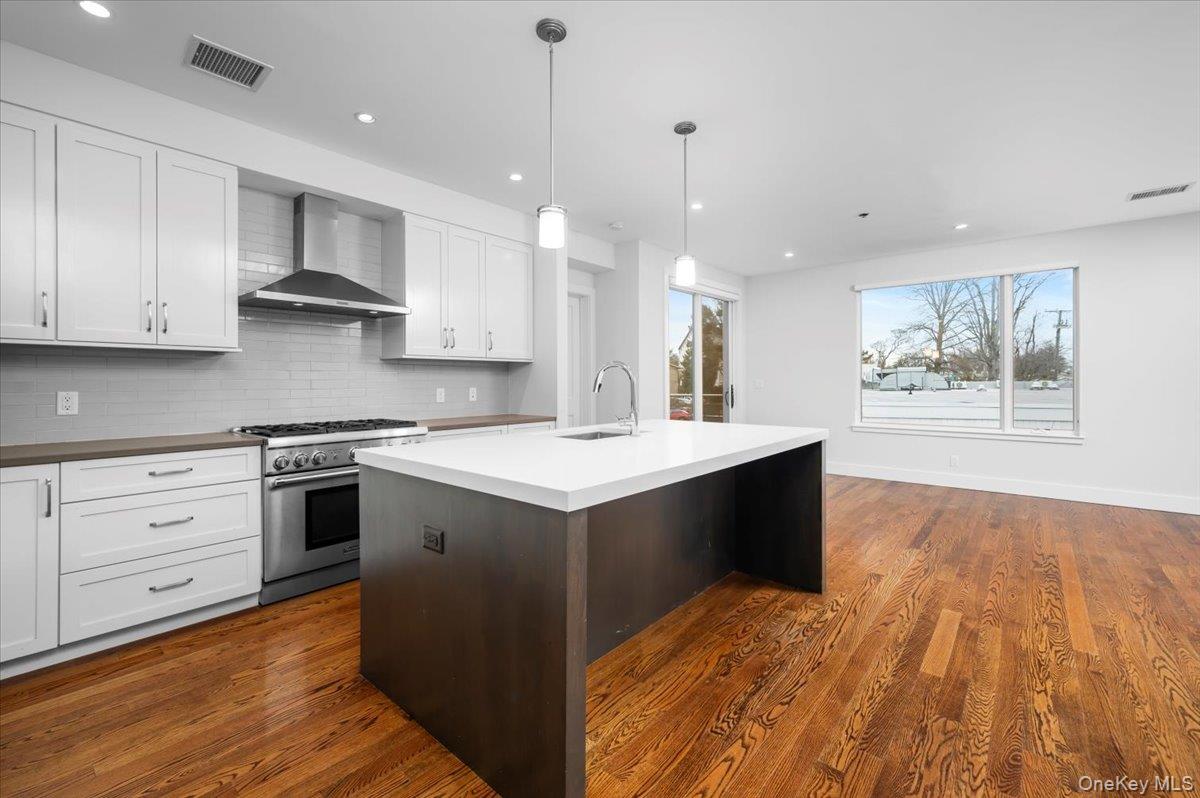 422 East Boston Post Road, Unit 303 Mamaroneck, NY 10543 - Photo 2 of 23 a kitchen with stainless steel appliances granite countertop a stove and a sink