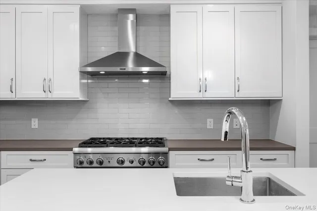 a kitchen with a stove and cabinets