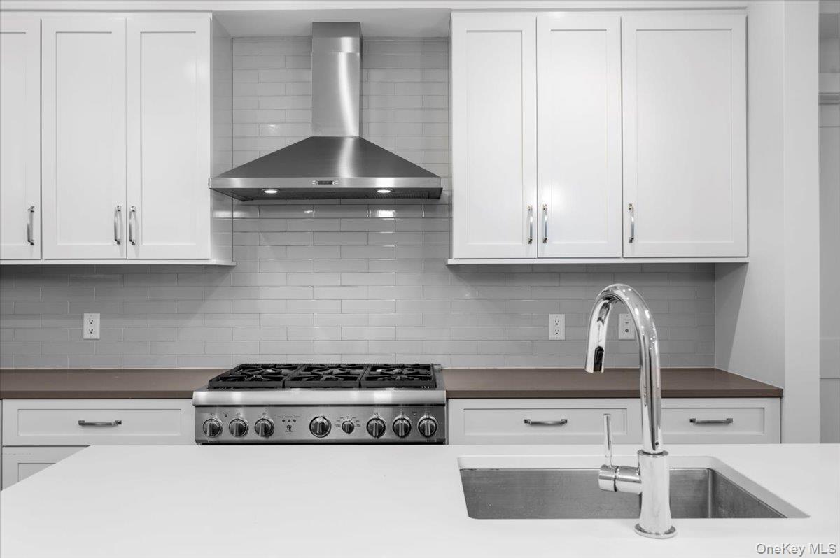 422 East Boston Post Road, Unit 303 Mamaroneck, NY 10543 - Photo 3 of 23 a kitchen with a stove and cabinets