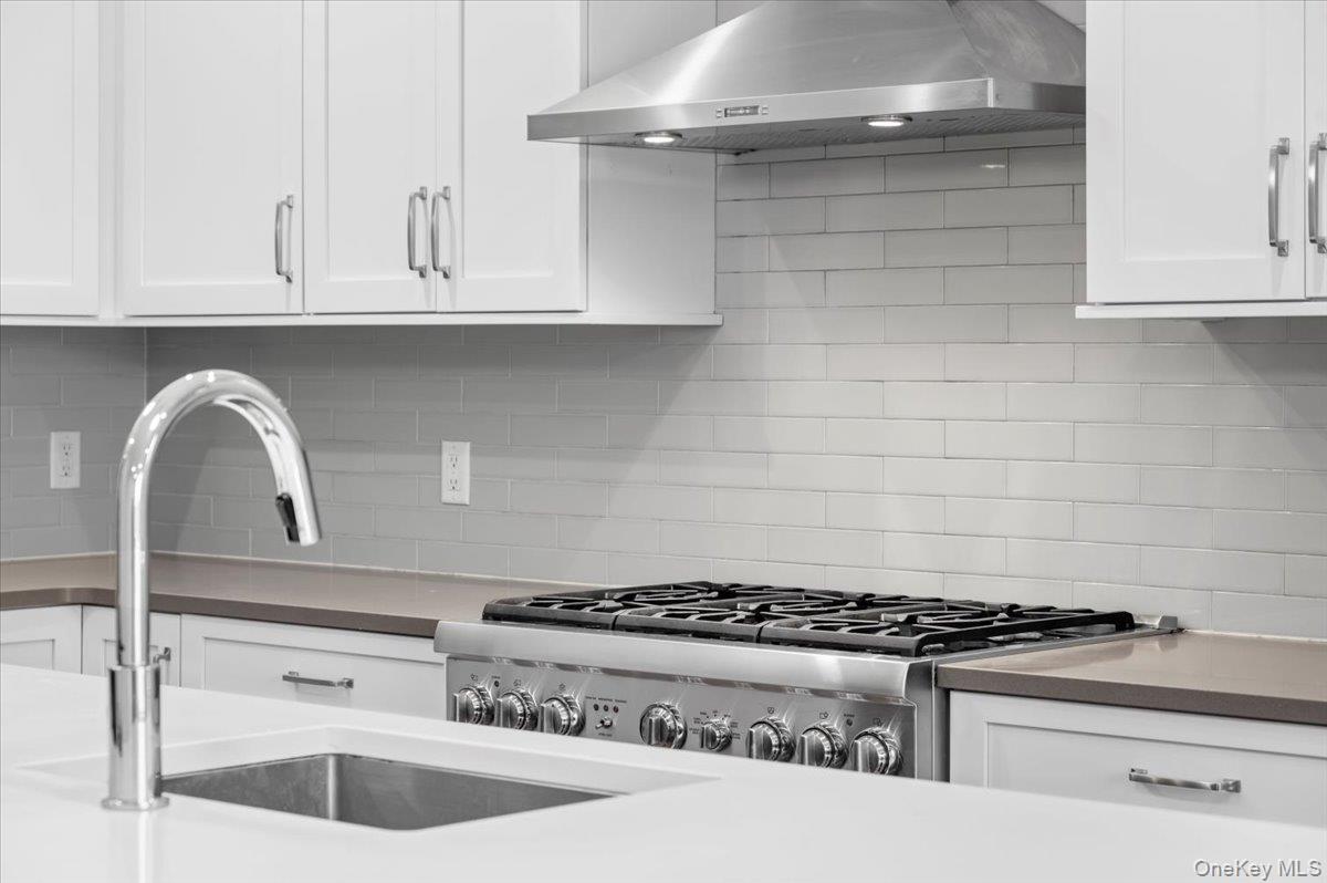 422 East Boston Post Road, Unit 303 Mamaroneck, NY 10543 - Photo 5 of 23 a stove top oven sitting inside of a kitchen