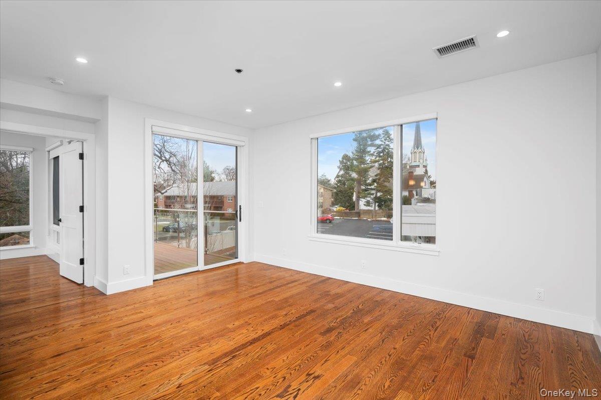 422 East Boston Post Road, Unit 303 Mamaroneck, NY 10543 - Photo 8 of 23 a view of an empty room with wooden floor and a window