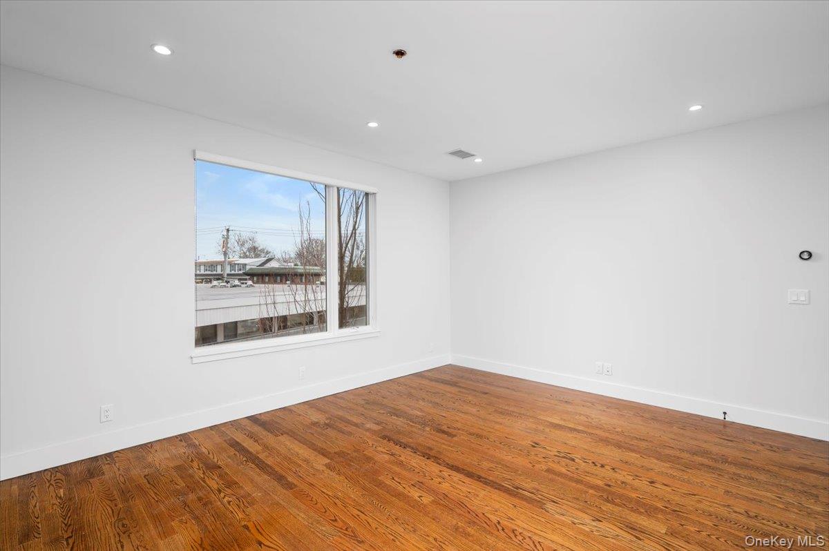 422 East Boston Post Road, Unit 303 Mamaroneck, NY 10543 - Photo 9 of 23 a view of empty room with wooden floor and fan