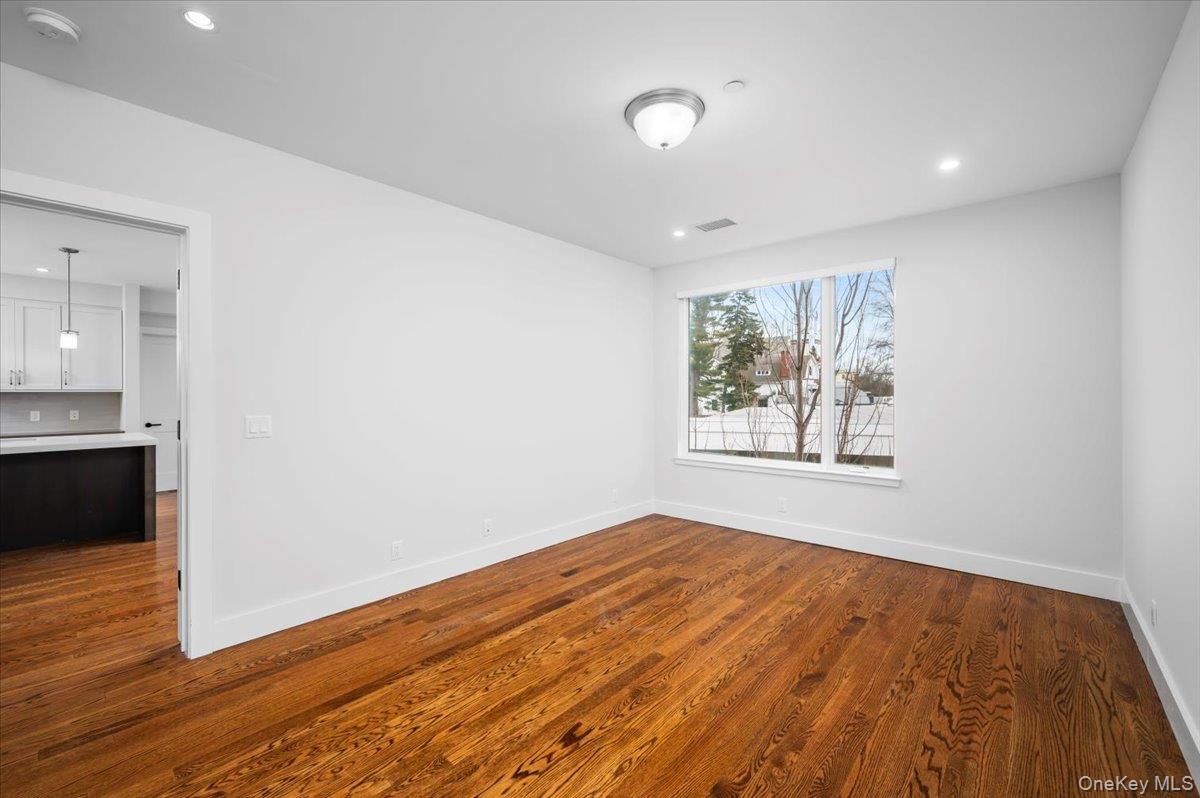 422 East Boston Post Road, Unit 303 Mamaroneck, NY 10543 - Photo 10 of 23 a view of an empty room with wooden floor and a window