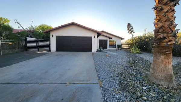 a view of a house with a yard and garage
