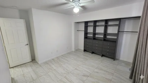 a view of an empty room with a cabinet