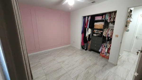 a view of a livingroom with wooden floor and a closet