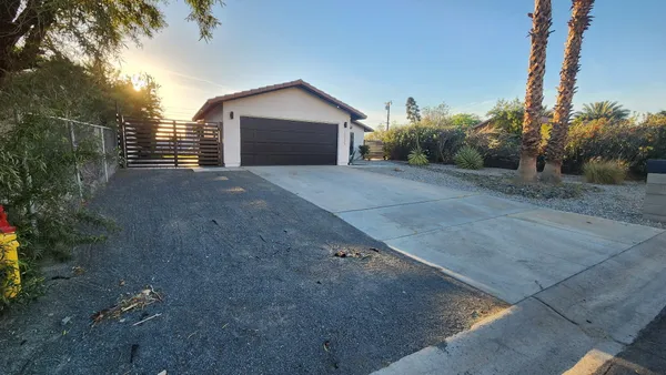 a view of a house with a yard and garage