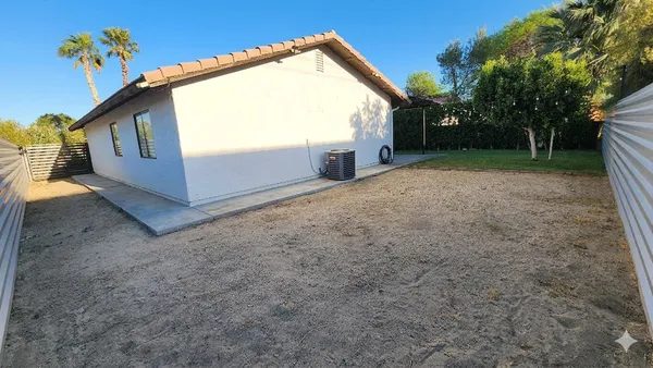 a view of backyard with a garden and deck