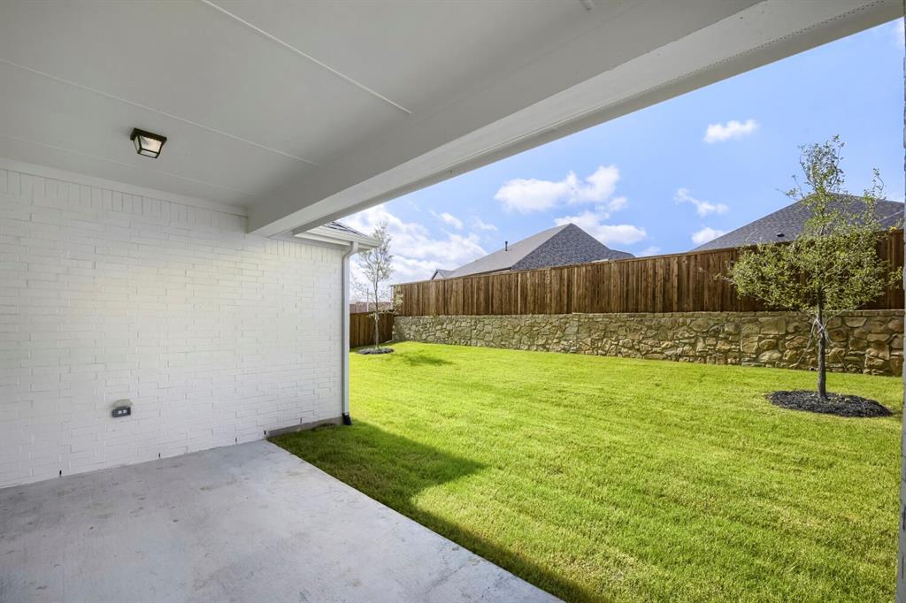 800 Blackberry Road Haslet, TX 76052 - Photo 25 of 28 Covered concrete patio with a white painted brick exterior wall