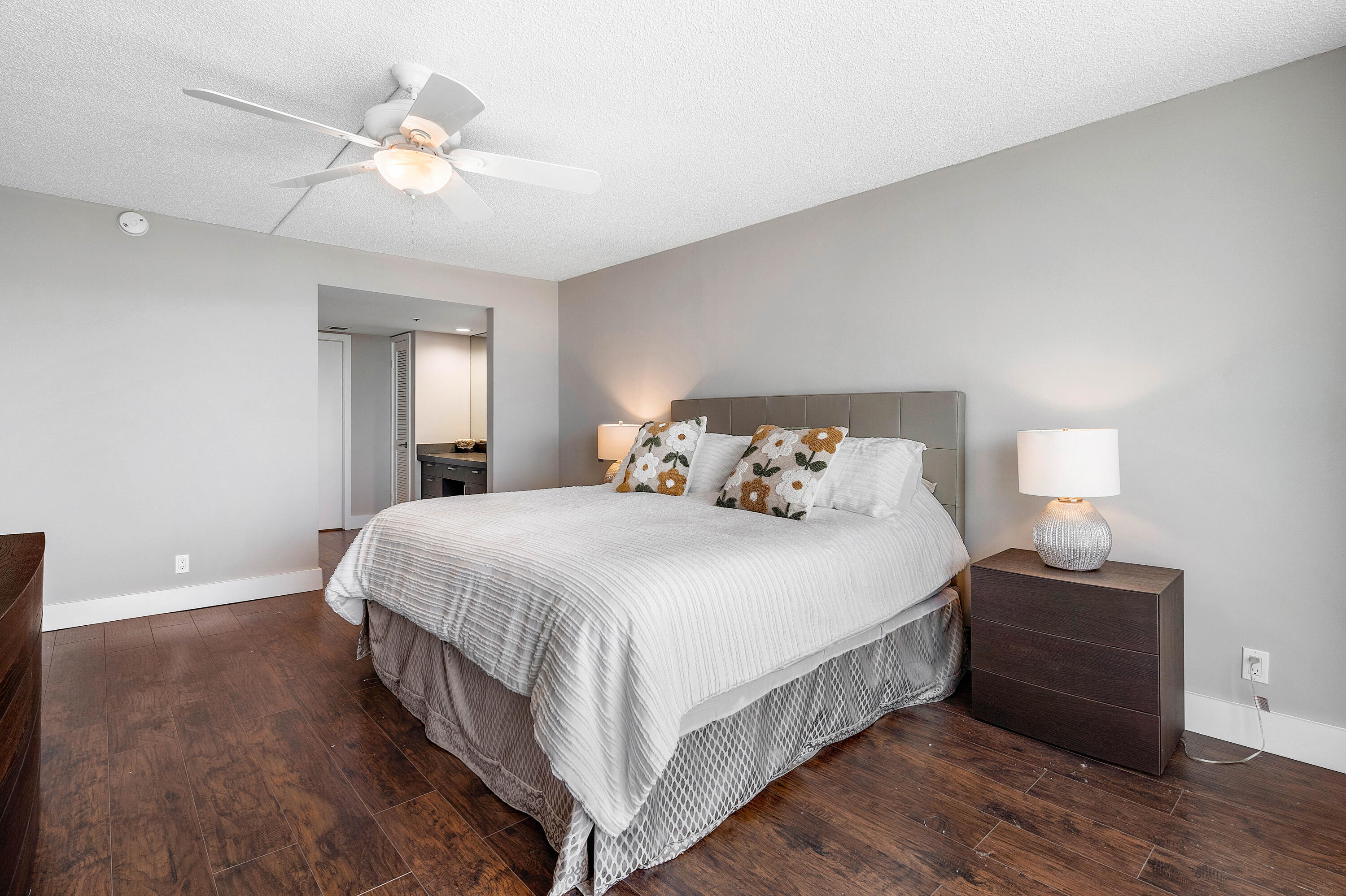 250 South Ocean Boulevard, Unit 7E Boca Raton, FL 33432 - Photo 21 of 45 a bedroom with a bed and a chandelier