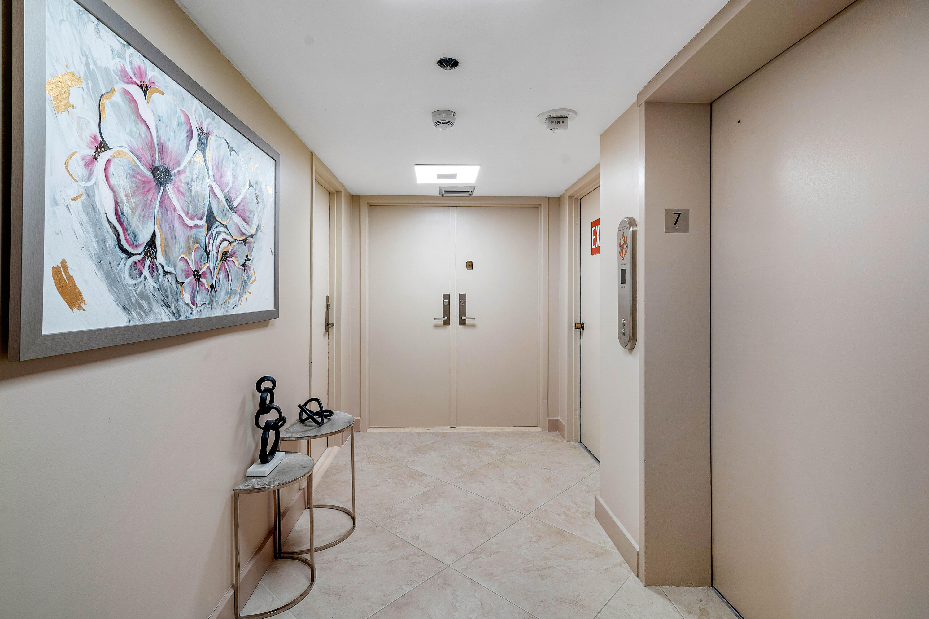 250 South Ocean Boulevard, Unit 7E Boca Raton, FL 33432 - Photo 4 of 45 a view of a hallway with paintings on the wall