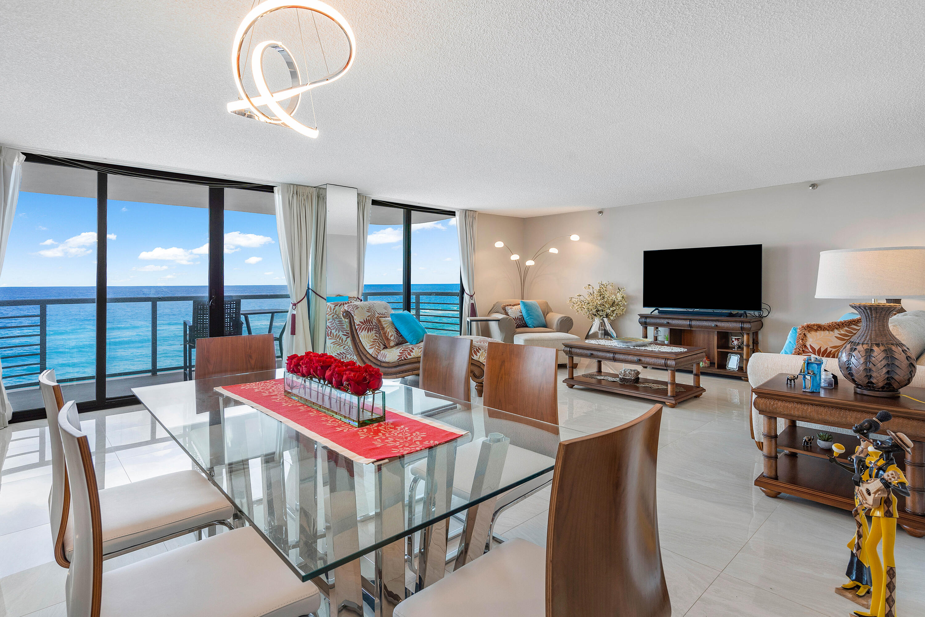 250 South Ocean Boulevard, Unit 7E Boca Raton, FL 33432 - Photo 7 of 45 a living room with furniture and a flat screen tv